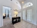 Bright foyer with tile flooring and double front doors, creating a welcoming entry at 925 Montana Ave, Davenport, FL 33897