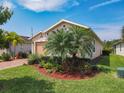 A charming single-Gathering home featuring lush landscaping, lawn and covered entry at 105 Palazzo Ln, Kissimmee, FL 34759