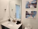 Modern bathroom with stylish vanity, decor, and decorative art at 1058 Splash Shot Pl, Davenport, FL 33896