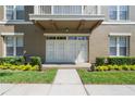 Charming entryway with large glass doors and well-kept garden landscaping at 1231 Wright Cir # 108, Kissimmee, FL 34747