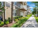Inviting condo exterior showcasing manicured landscaping and architectural charm at 1231 Wright Cir # 108, Kissimmee, FL 34747