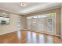 Bright living room featuring hardwood floors and elegant French doors at 1231 Wright Cir # 108, Kissimmee, FL 34747