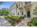 Inviting front exterior of a townhome featuring a well-manicured yard and sidewalk at 1303 Artisan E Ave, Celebration, FL 34747