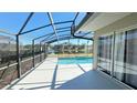 Relaxing screened patio with a view of the pool and tranquil lake at 16732 Glenbrook Blvd, Clermont, FL 34714