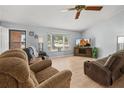 Inviting living room with light wood flooring, a bay window, and comfortable seating at 1700 E Clinton Dr, St Cloud, FL 34769