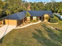 Aerial view of a stunning home, showcasing the driveway and lush green lawn at 1849 Kings Point Blvd, Kissimmee, FL 34744
