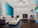 Chic living room with white leather sofa, fireplace, and stylish decor at 1849 Kings Point Blvd, Kissimmee, FL 34744