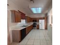 Functional kitchen equipped with stainless steel appliances, wood cabinets, and sleek countertops at 1948 Bridgeview Cir, Orlando, FL 32824