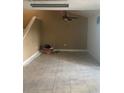 Spacious living room with tile flooring, ceiling fan, and a staircase leading to upper level at 228 Scottsdale Sq # 228, Winter Park, FL 32792