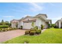 Charming villa featuring a red brick driveway and lush landscaping at 2503 Yellow Brick Rd, St Cloud, FL 34772