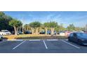 Well-organized parking lot with several parked cars on a sunny day at 3038 Parkway Blvd # 204, Kissimmee, FL 34747