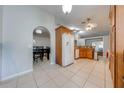 Bright kitchen featuring tile floors, granite countertops, wood cabinetry, and stainless steel appliances at 3160 Santa Cruz Dr, Kissimmee, FL 34746