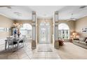 Welcoming foyer with decorative columns, elegant lighting, and tiled floor at 3256 Countryside View Dr, St Cloud, FL 34772