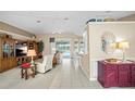 Spacious living area featuring tile floors and an open design with access to the outdoor pool at 3256 Countryside View Dr, St Cloud, FL 34772