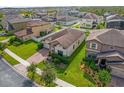 Aerial view of a house in a residential neighborhood featuring manicured lawns and proximity to nearby homes at 3366 Puxton Dr, Orlando, FL 32824