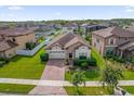 Aerial view of a single Gathering home in a well-maintained neighborhood with green lawns and a brick paver driveway at 3366 Puxton Dr, Orlando, FL 32824