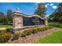 Stone entrance sign for The Estates at Stevens Plantation, surrounded by colorful flowers at 3551 Buckingham Ct, St Cloud, FL 34772