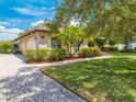 Attractive home exterior with a three-car garage, brick accents, and a paved driveway at 3551 Buckingham Ct, St Cloud, FL 34772