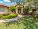 Beautifully landscaped front yard featuring lush green grass and a brick walkway leading to the entrance at 3551 Buckingham Ct, St Cloud, FL 34772