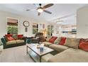 Bright and airy living room featuring tile floors, an open layout, and seamless access to the kitchen and dining area at 3881 Wind Dancer Cir, St Cloud, FL 34772