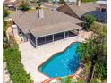 Aerial view of a backyard with a pool, screened lanai, and well-maintained landscaping at 404 N Sundance Dr, Lake Mary, FL 32746