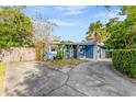Exterior view of a home featuring a circular driveway and a well-maintained yard at 407 S Lakemont Ave, Winter Park, FL 32792