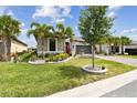 Beautifully landscaped front yard with palm trees and lush green grass at 433 Via Abruzzi St, Kissimmee, FL 34759