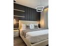 Beautiful bedroom showcasing a panel accent wall with unique lighting fixtures at 4473 Kaipo Rd, Davenport, FL 33897