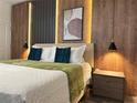 Stylish bedroom featuring a modern headboard, unique lighting, and wood accent walls at 4473 Kaipo Rd, Davenport, FL 33897