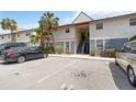 Exterior angle of condo featuring staircase entry and maintained landscaping at 4722 Kilt Ct # 65, St Cloud, FL 34769