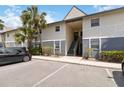 Exterior angle of condo featuring staircase entry and maintained landscaping at 4722 Kilt Ct # 65, St Cloud, FL 34769