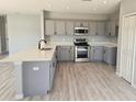 Modern kitchen with quartz countertops, stainless steel appliances, and ample cabinet space at 511 Elbridge Pl, Kissimmee, FL 34758