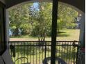 A cozy balcony featuring green space and wrought-iron railing offering relaxing outdoor space at 5501 G Nw Ave # 4714, Orlando, FL 32815