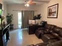 The living room features tile floors and a sliding glass door for ample natural light and outdoor access at 5501 G Nw Ave # 4714, Orlando, FL 32815
