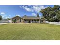 Well-maintained lawn leading up to a charming house with a covered front porch at 5572 Myakka Ave, Intercession City, FL 33848