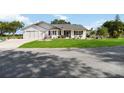 Inviting single-level home with an attached garage and meticulously maintained landscaping at 5919 Mcenroe Ct, Leesburg, FL 34748