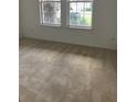Bright bedroom with neutral carpet and natural light coming through two windows at 6806 Trellis Vine Loop, Windermere, FL 34786
