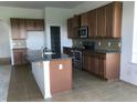 Spacious kitchen features granite countertops, an island, and modern stainless steel appliances at 6806 Trellis Vine Loop, Windermere, FL 34786
