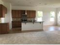 Bright, open kitchen with granite countertops, stainless steel appliances, and breakfast bar at 6806 Trellis Vine Loop, Windermere, FL 34786