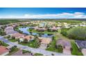 Gorgeous aerial view of a lakefront community featuring beautiful homes and lush landscaping under a clear blue sky at 772 San Raphael St, Kissimmee, FL 34759