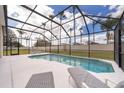 Enjoy the refreshing pool in this screen enclosed lanai, perfect for relaxation and outdoor entertainment at 8217 Fan Palm Way, Kissimmee, FL 34747