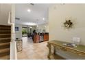 Welcoming entryway leads to an open-concept kitchen and dining area, featuring tile floors at 9163 Wedge Dr, Davenport, FL 33896