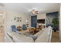 Comfortable living room featuring stylish furniture, tile floors, and a mounted TV at 9163 Wedge Dr, Davenport, FL 33896