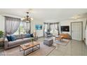 Staged living room boasts tile floors, neutral walls, and ample natural light at 1038 Sabine Pl, Kissimmee, FL 34759