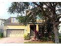 Charming two-story home with a well-maintained lawn, a two-car garage and mature trees in the front yard at 12867 Woodmere Close Dr, Windermere, FL 34786