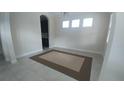 Bright living room featuring tile floors, neutral walls, and three windows letting in natural light at 12867 Woodmere Close Dr, Windermere, FL 34786