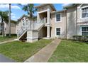 Beautiful two-story condo featuring a private entrance and lush landscaping at 13427 Fairway Glen Dr # 103, Orlando, FL 32824