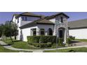 Attractive home with a stone facade, manicured lawn, mature landscaping, and located on the corner at 15079 Guava Bay Dr, Winter Garden, FL 34787