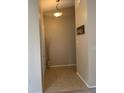 Inviting entryway with neutral tones, tile flooring, decorative vase, and a welcoming 'Home' sign at 1561 Cypress Woods Cir, St Cloud, FL 34772