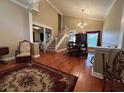 Open-concept living room and dining area with high ceilings, hardwood floors, and a staircase to the second floor at 1835 Harbor Blvd, Kissimmee, FL 34744
